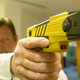 A policeman holds the new advanced taser gun April 4, 2003, as the Metropolitan police introduced the Taser gun to the press in London.